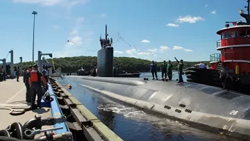US Navy submarine at a shipyard undergoing maintenance, illustrating plans to build a fifth shipyard for the US Navy