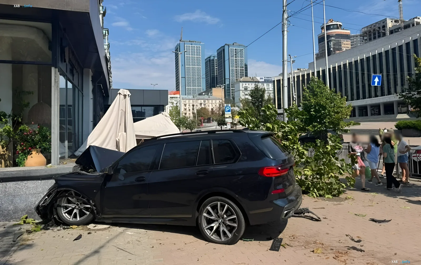 Разбитый черный BMW врезался в летнюю террасу ресторана в центре Киева, рядом стоят свидетели аварии