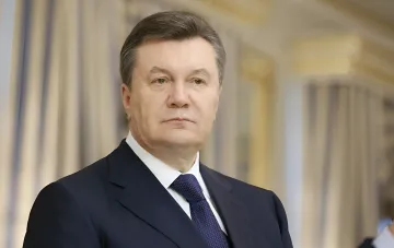 Viktor Yanukovych in a formal suit, symbolizing the lives of ousted leaders in Russia in 2026