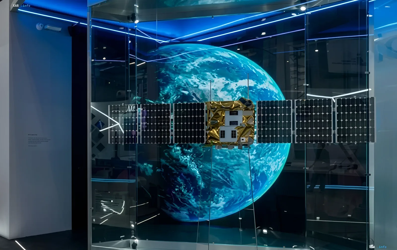 Model of Russian military satellite system 'Rassvet' in a museum with Earth in the background