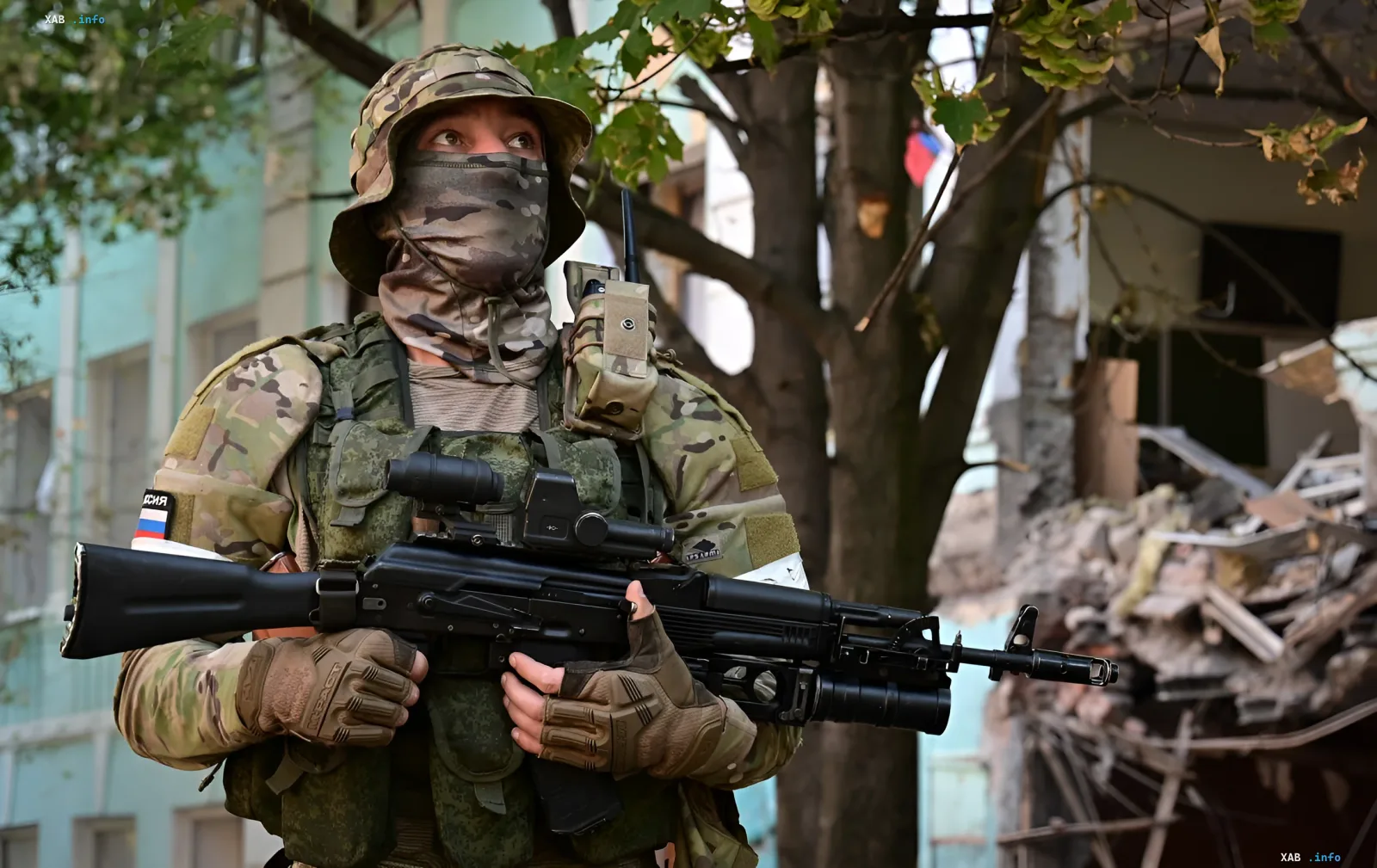 Russian soldier in camouflage with weapon and Russian flag on sleeve — example of foreign mercenaries marked by inventory number system to conceal losses