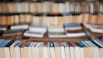 Shelves filled with old paper books, symbolizing raw material for AI training after the 2025 court ruling