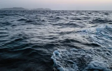 Meereswellen vor dem Horizont, die den Hormuz-Engpass im Kontext des iranischen Ultimatums an die USA symbolisieren
