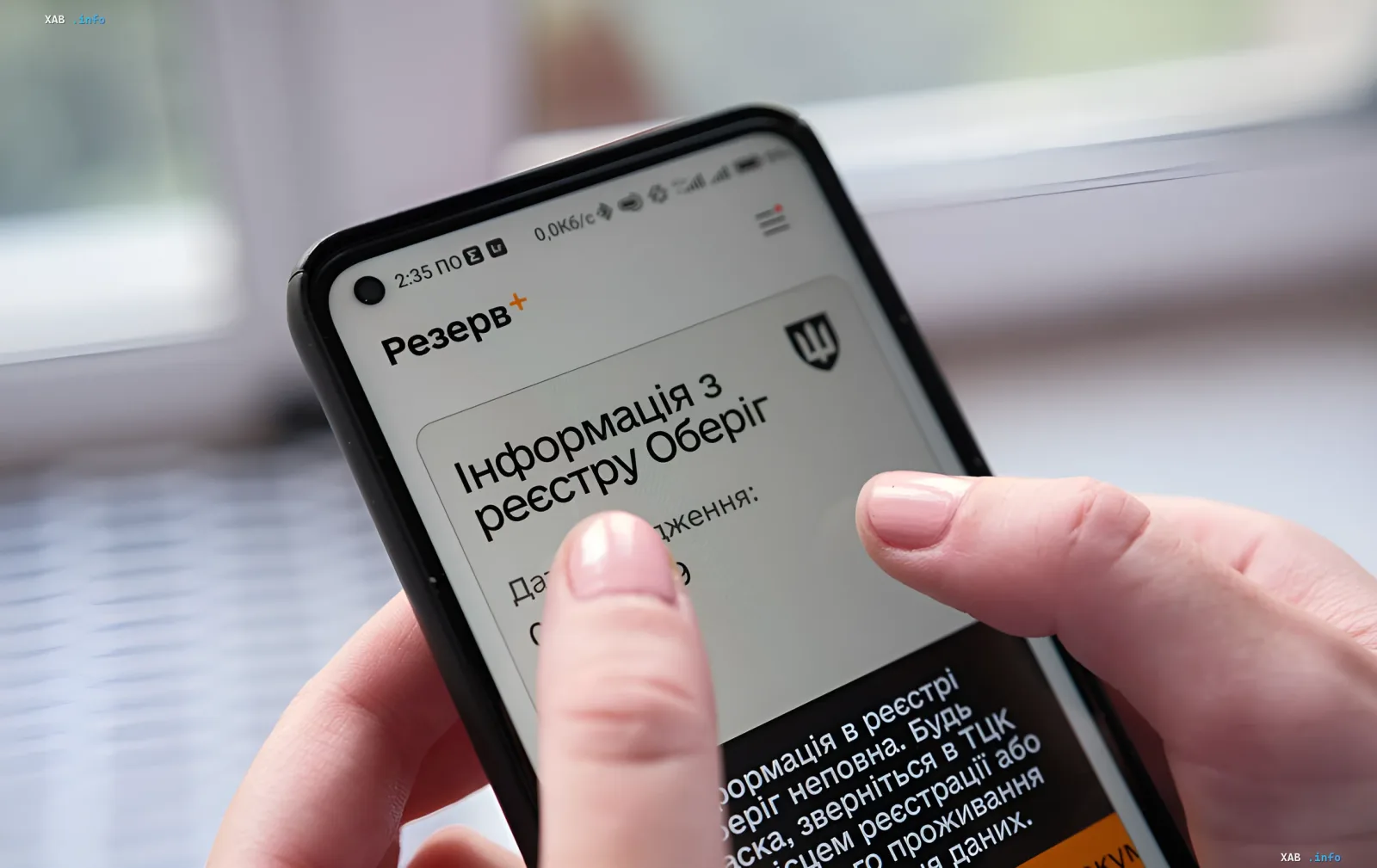 Смартфон з додатком «Резерв+» на екрані, де відображається інформація з реєстру Оберіг — ілюстрація цифрової мобілізації та онлайн-відстрочки для педагогів