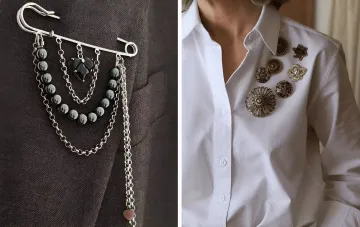 Moderne Trageweisen für Broschen im Herbst 2026: eine Designer-Sicherheitsnadel-Brosche mit Anhängern und ein Cluster Vintage-Broschen auf einem weißen Hemd