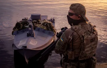 Украинский боец СБУ и многоцелевой морской дрон-камикадзе на закате