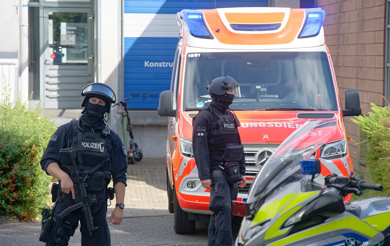 German police officers in tactical gear next to a service vehicle during an investigation into a sabotage scheme near Berlin