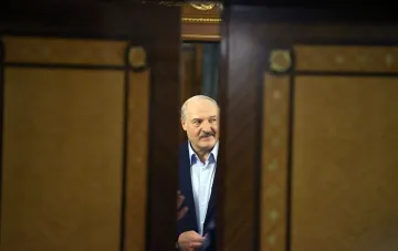 Alexander Lukashenko standing in a doorway during an official meeting related to the changing US-Belarus diplomatic relations