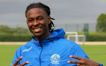 Portrait of 25-year-old midfielder Kevin Castro in a blue training jacket on a football pitch before a friendly match