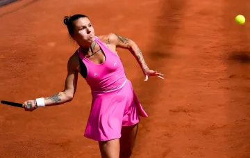 Tennis player in a pink outfit hitting the ball on a clay court amid the controversy over Kalinina and Bondar's doubles pairing at US Open-2026