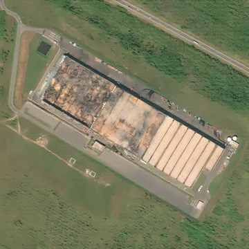 Satellite image of the Ozon warehouse in Chapaevsk after a drone strike: burned roof sections visible