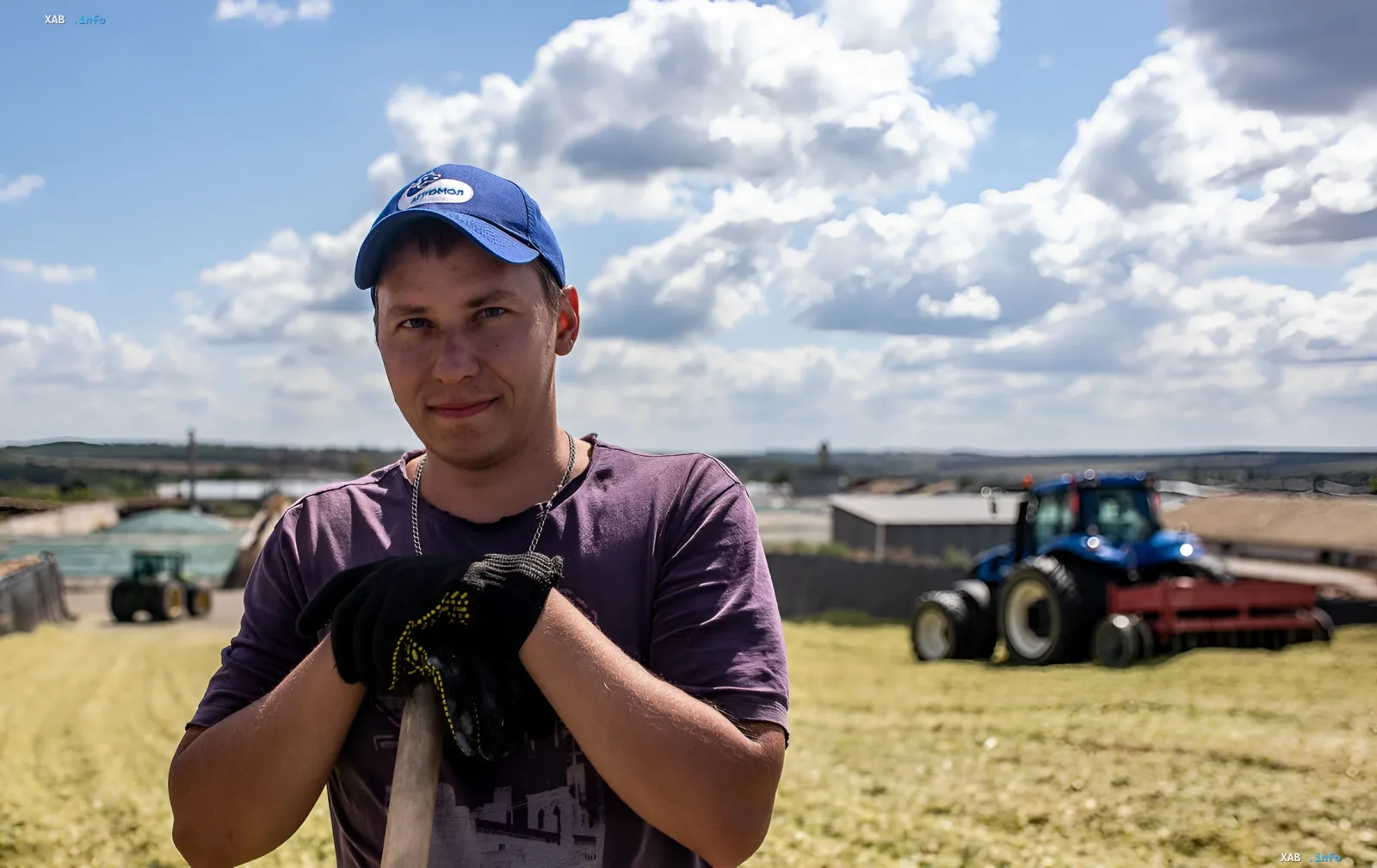 Farmer with a shovel in front of fields and tractors: land tax and agriculture in local budgets