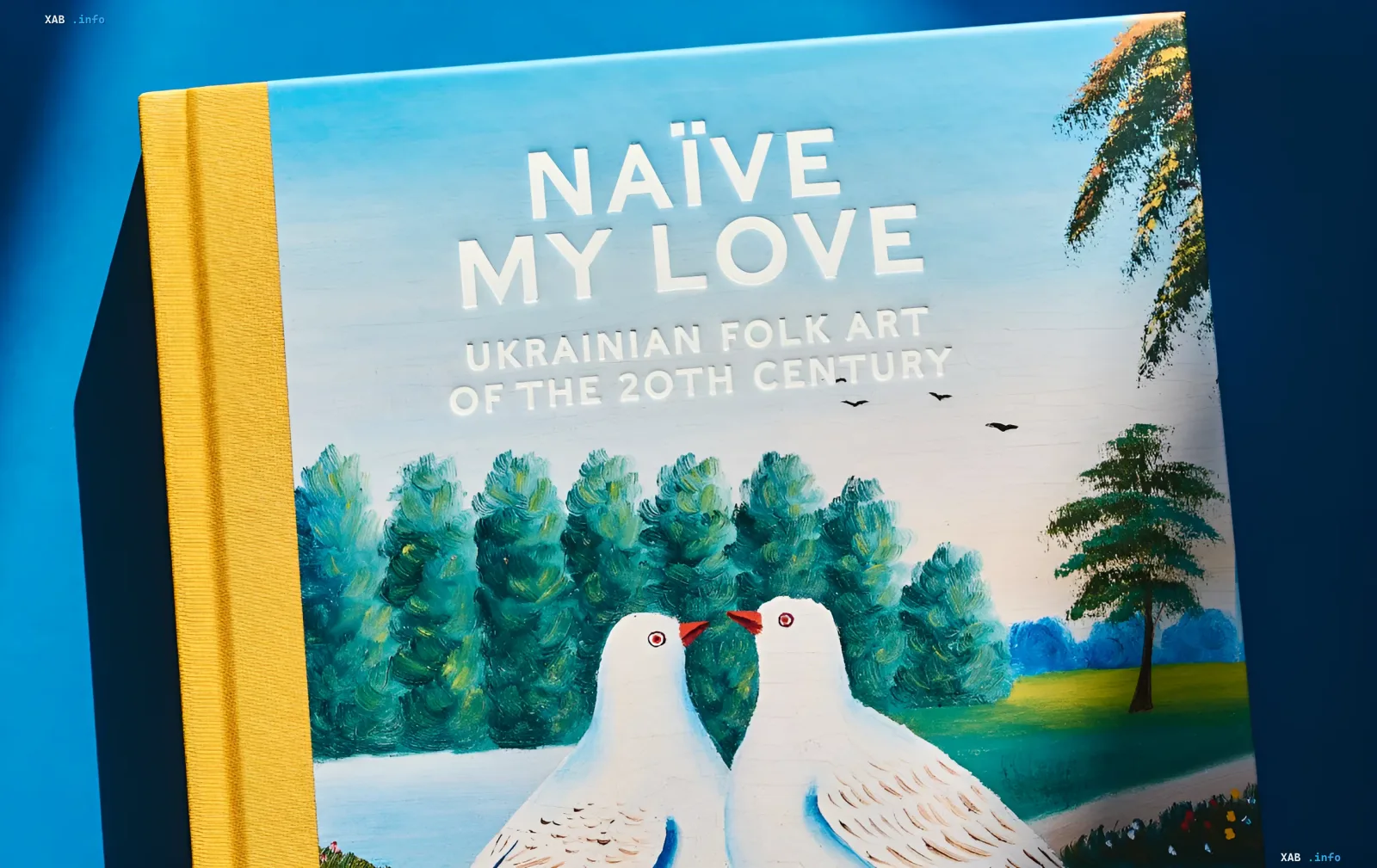Обложка книги Naïve My Love: Ukrainian Folk Art of the 20th Century от GUNIA Project и Assouline с изображением двух белых голубей и пейзажем в стиле украинского наивного искусства
