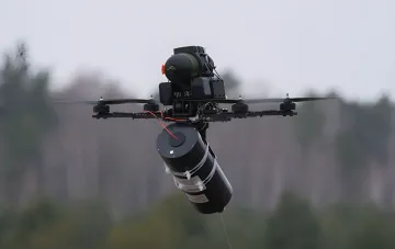 Ukrainian FPV drone with an under-slung warhead in flight — a product of the defense industry