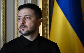 President Zelensky in a black shirt against the Ukrainian flag during his 35th Independence Day address