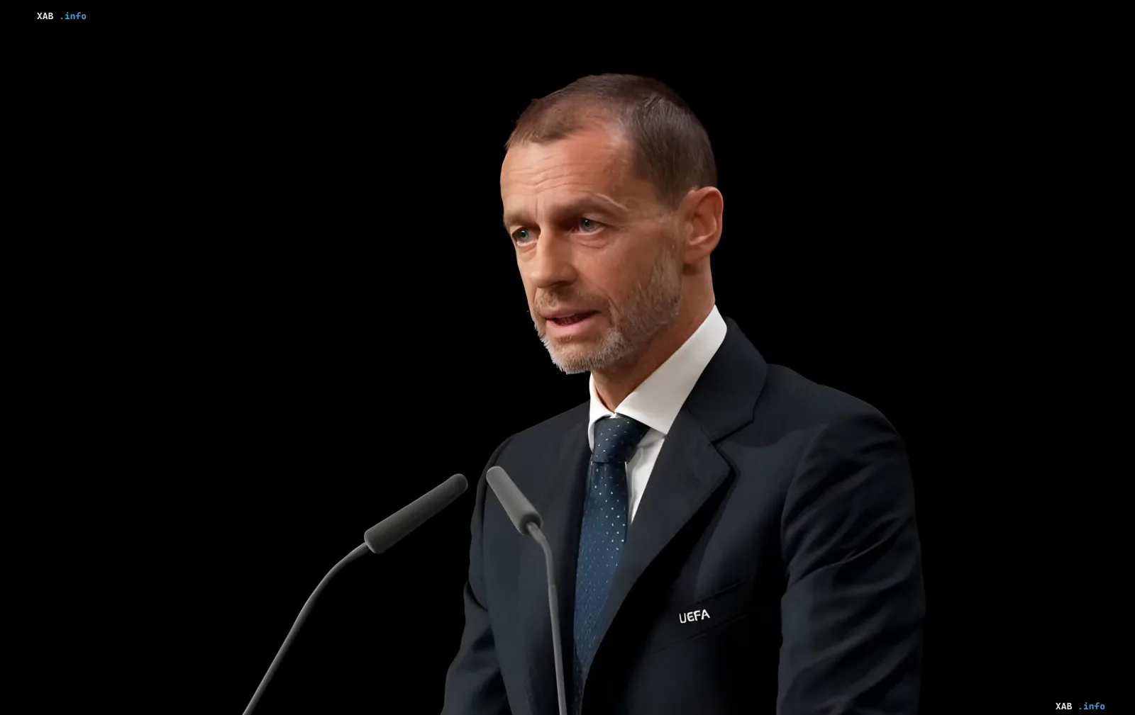 UEFA President Aleksander Ceferin in a dark suit at a microphone with the UEFA logo on his lapel, having declined the FIFA presidency
