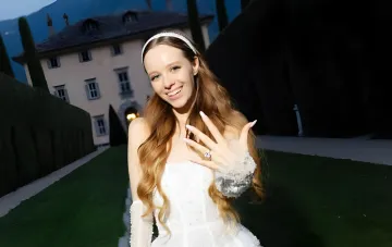Irina Kudashova shows off her diamond engagement ring in front of a villa on the shores of Lake Como