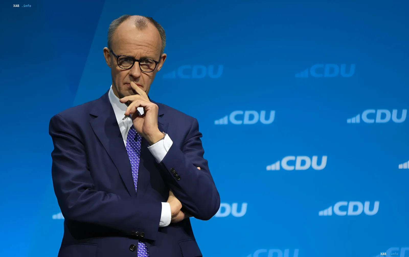 Friedrich Merz in front of CDU party logos commenting on the attack on Ukrainian An-124 in Leipzig