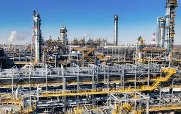 Under-construction Amur Gas Chemical Complex: industrial columns, pipelines and platforms under a clear sky — site of a 2,000 sq m fire