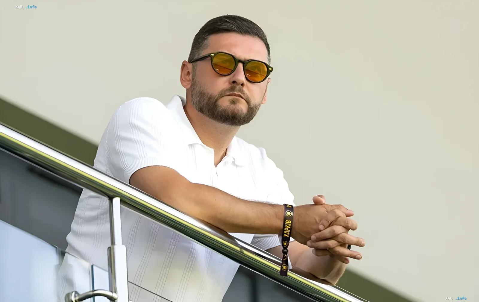 FC Kharkiv representative on the stadium tribune wearing sunglasses and a club wristband amid the Sydorov transfer dispute