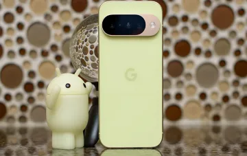 Lime-green Google Pixel 11 smartphone with camera bar and G logo next to an Android figurine — the Tensor G6 flagship chip that disappointed in performance