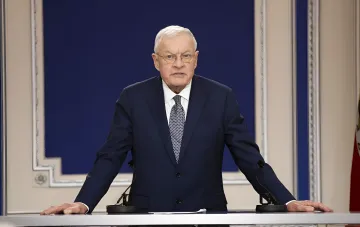 Kurt Kellogg at an official podium with microphones, explaining Russian strikes on Ukraine during his visits