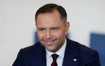 President of Poland Dariusz Nawrocki in a suit with a Polish flag pin on his official portrait