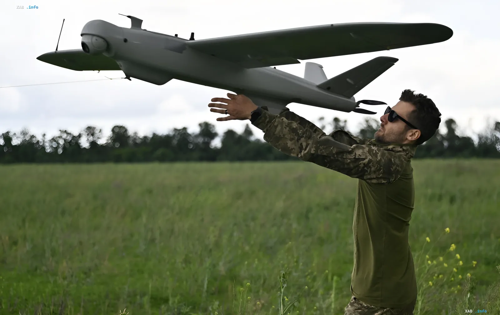 Ukrainian soldier launches a tactical drone in a field ahead of the night wave of drone strikes on an oil refinery and Wildberries warehouse