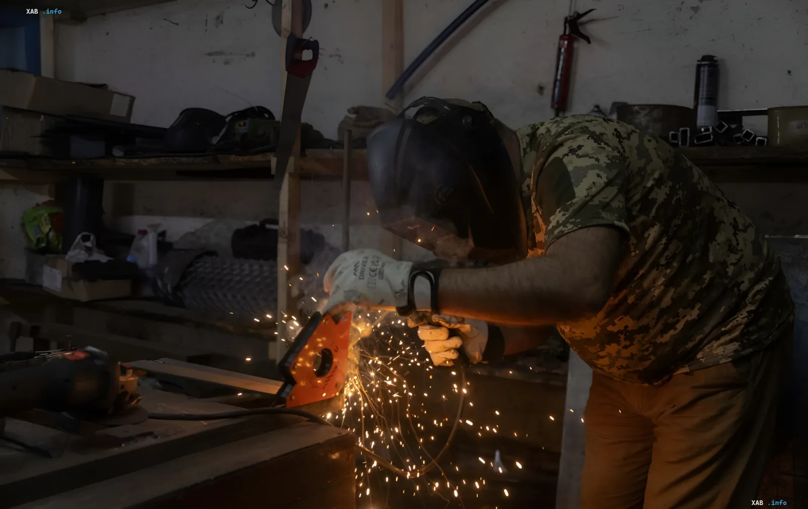 Arbeiter mit Schweißmaske schweißt Metall in einer ukrainischen DefenseTech-Fabrik, die die Rüstungsproduktion ausbaut