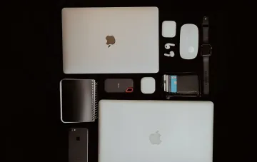 Apple device ecosystem: MacBook, iPad, iPhone, AirPods and Apple Watch on a black background ahead of the September 9 «Surprise and shine» event featuring the foldable iPhone Ultra
