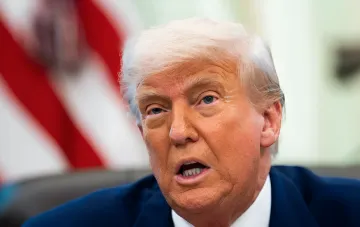 Donald Trump in front of the American flag during a statement on declaring a state of emergency over threats to the US power grid from foreign equipment
