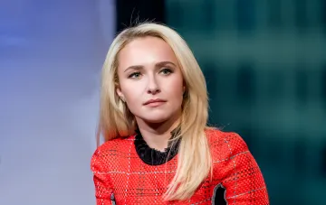 Actress from the TV series Heroes in a red dress at an event honoring Hayden Panettiere's memory