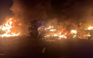 Fire at the Nova Poshta sorting center in Sumy after Russian KAB strikes: a burning truck and building debris at night