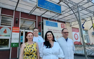 Staff of Zhytomyr City Hospital No. 1 in front of the maternity ward sign, where the new cardiac monitoring system will be installed