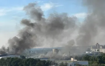 Thick smoke rising over Belgorod after a missile strike on Estate Logistics warehouses