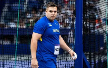 Ukrainian thrower Mykhailo Kokhan in the national team uniform at the throwing cage after winning silver at the Continental Tour in Brescia