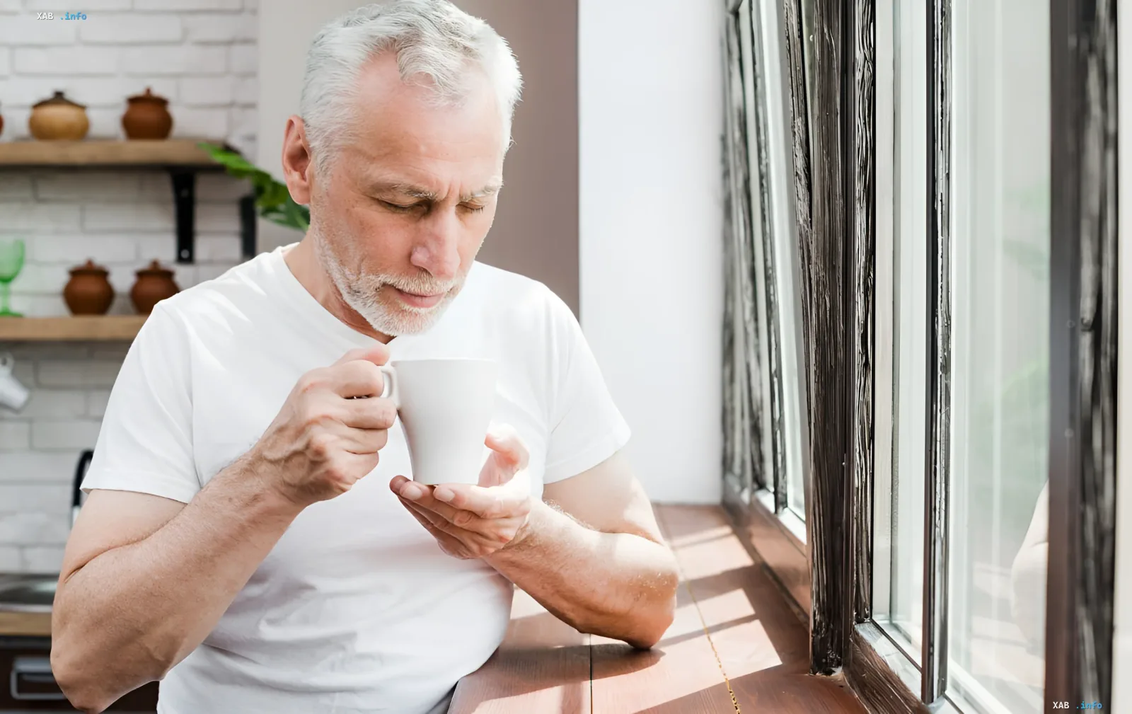 A man holds a cup of milk and looks at it thoughtfully — illustration for the topic of genetic lactose intolerance and gluten sensitivity