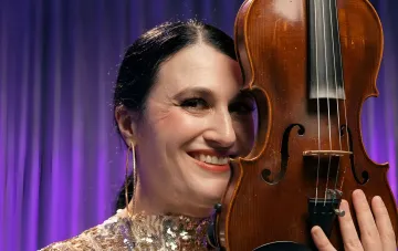 TikTok-Geigerin lächelt mit der Violine auf der Bühne von „Ukraine Has Talent“ vor ihrem gescheiterten Debüt