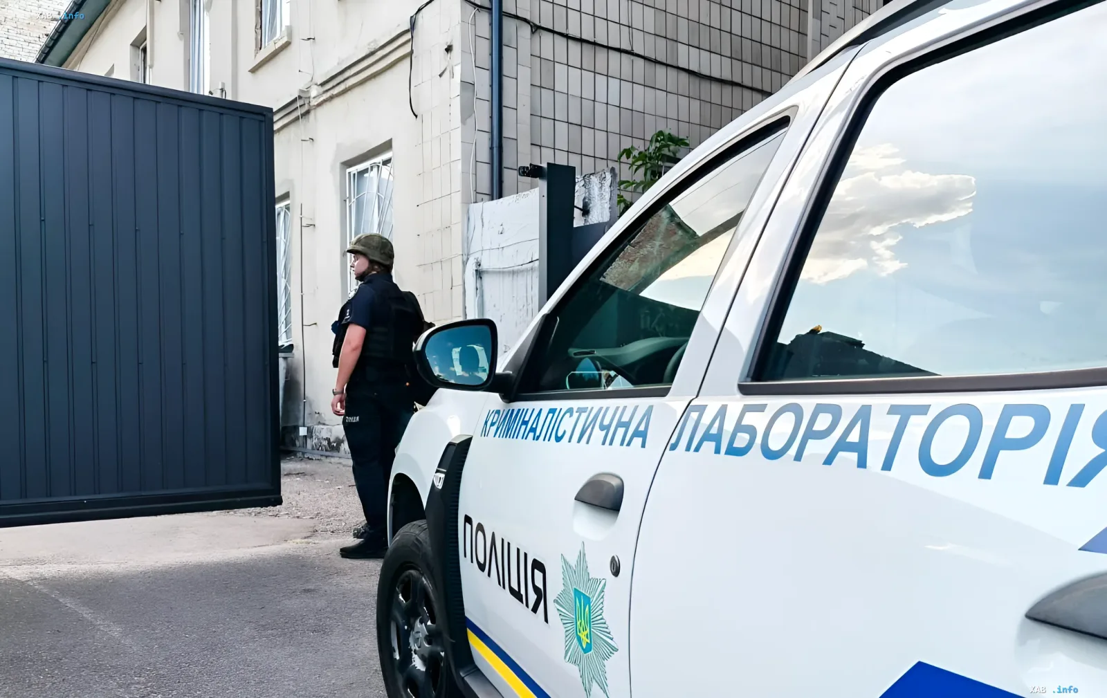 Polizeifahrzeug der kriminaltechnischen Laboratorien der Ukraine und ein Beamter am Ort der Explosion in der Polizeistation Rowno