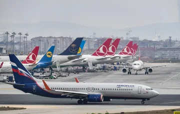 An Aeroflot jet on the runway of an international airport in front of foreign carriers' fleet — the airline's shares fell after Zelensky's 'closed sky' statement over Russia