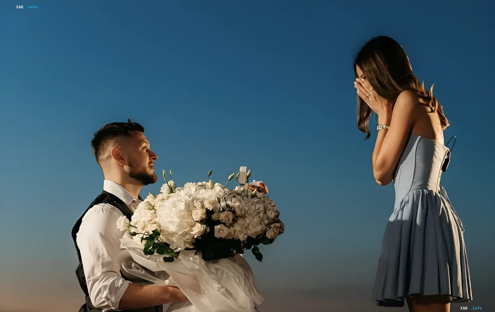 Mikhail Dzyuba proposes to Olesya Nadeeva: man with a bouquet of white flowers, woman in a blue dress covering her face with hands
