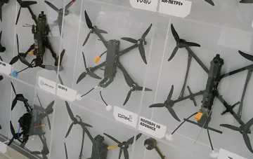 Display case with Ukrainian combat drone models at the interactive DOT-Chain Defence ordering installation in Kyiv