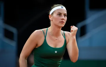 Теннисистка в зелёной форме Wilson с победным жестом на US Open-2026 в парном разряде