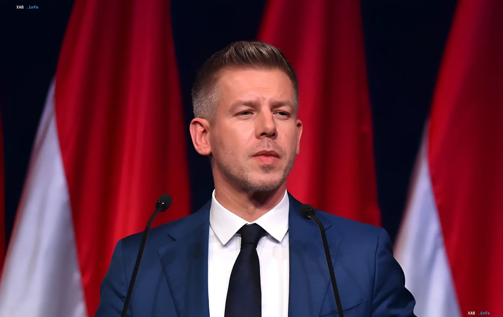 Hungarian politician Magyar speaks at a podium with Hungarian flags in the background, stating that Hungary will continue granting asylum to Ukrainian men of conscription age despite the EU decision