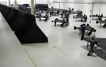 Conveyor assembly of Geran kamikaze drones at a Russian plant: workers at workbenches and rows of wings preparing the release of about 2000 jet-powered units