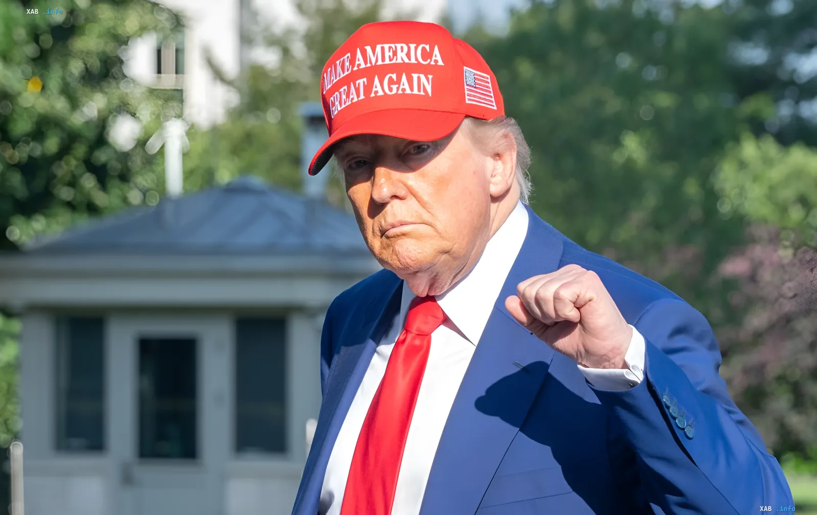 Donald Trump in a MAGA cap with a clenched fist gesture of determination in front of the White House — reposting the initiative to produce Patriot missiles in Ukraine