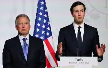 Stephen Witkoff and Jared Kushner in front of the US flag ahead of their Moscow trip for Ukraine talks
