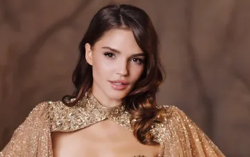 Valeria Lisovska in an evening gold gown with a jeweled cape for Miss World 2026