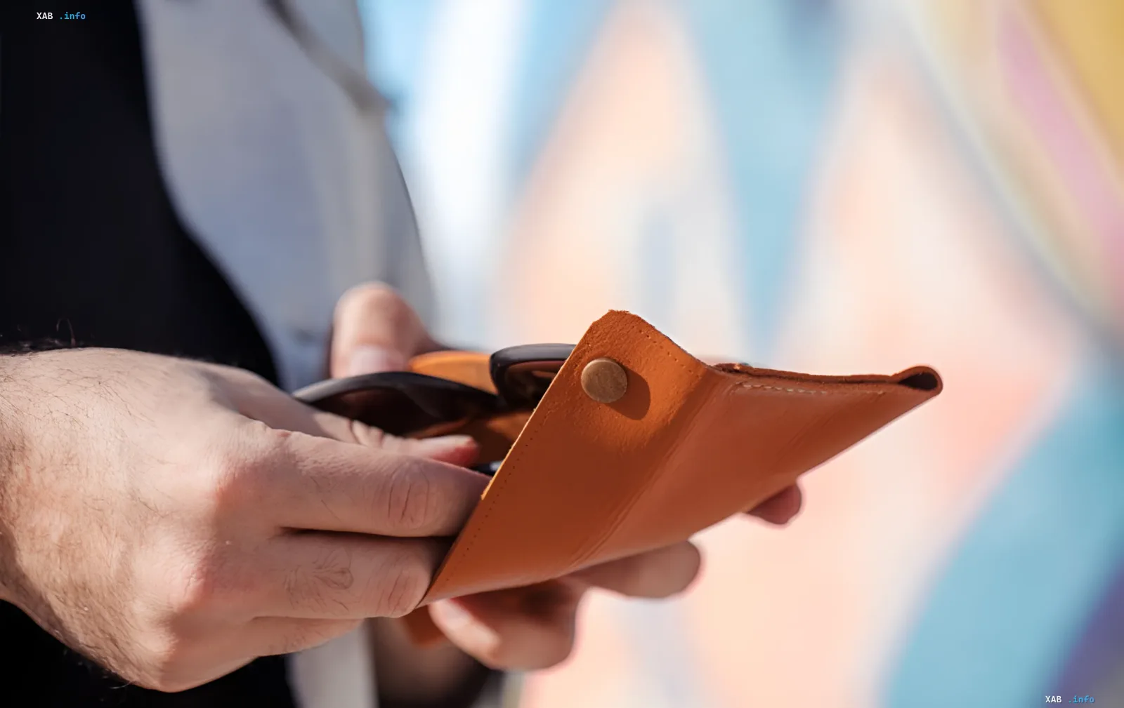 Hands holding an open leather wallet — a symbol of folk money superstitions and the bay leaf ritual for attracting wealth