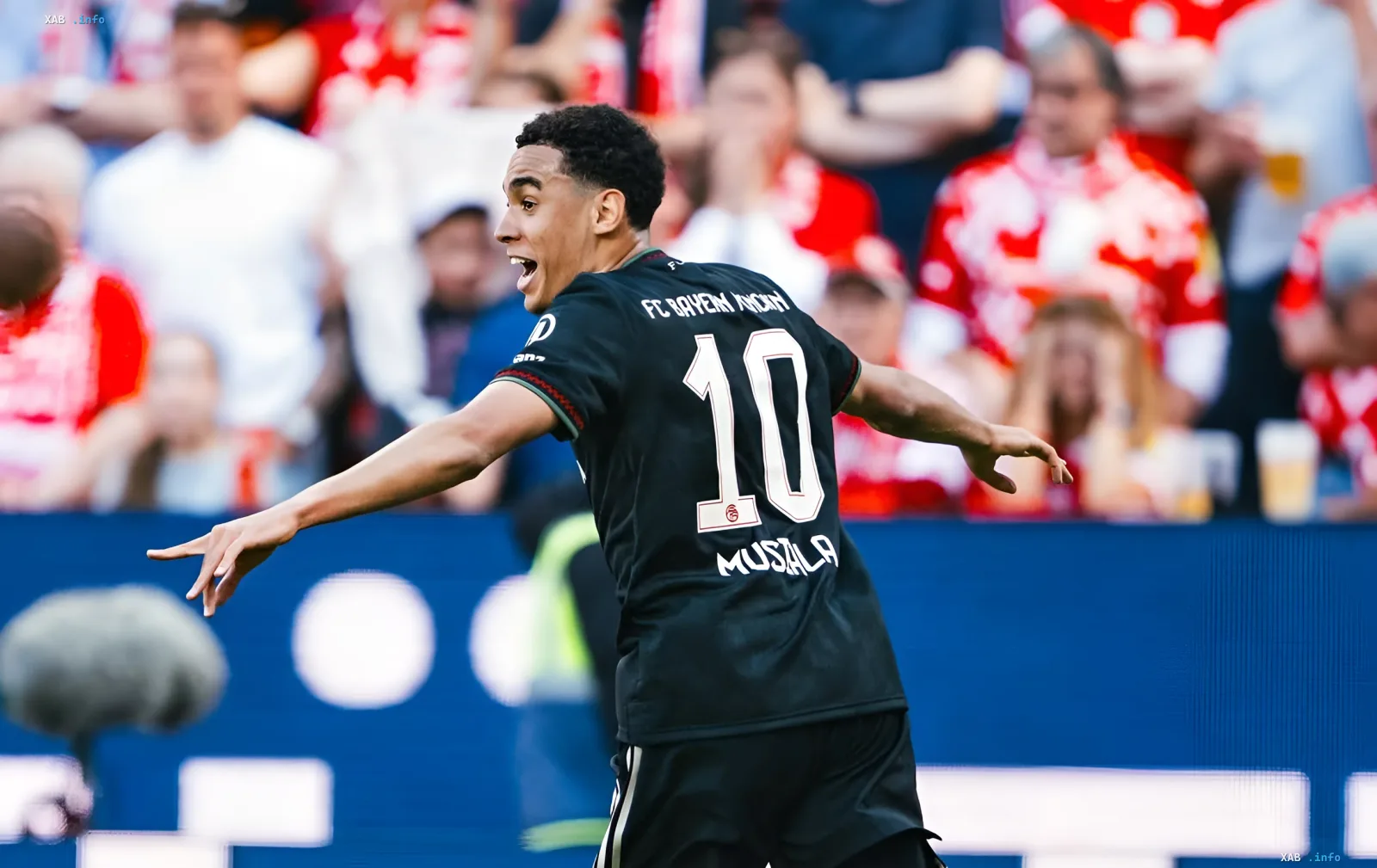 Jamal Musiala in a Bayern Munich number 10 kit celebrates during the match against Schalke after returning to the squad